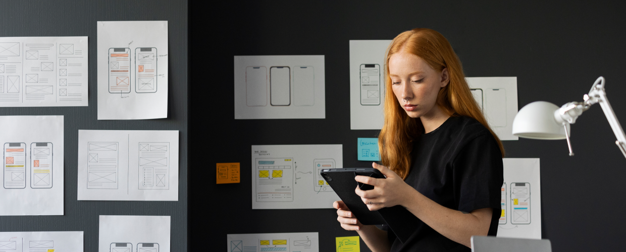 Hero Image for Awareness blog post #1 (2X: Increase Design Efficiency). An image of femal web designer in the office with notebook. Hero Image for Awareness blog post #1 (2X: Increase Design Efficiency). An image of femal web designer in the office with notebook.