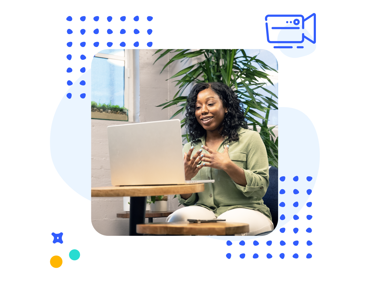 Decorative image of a woman sitting in front of a laptop speaking and gesturing with her hands