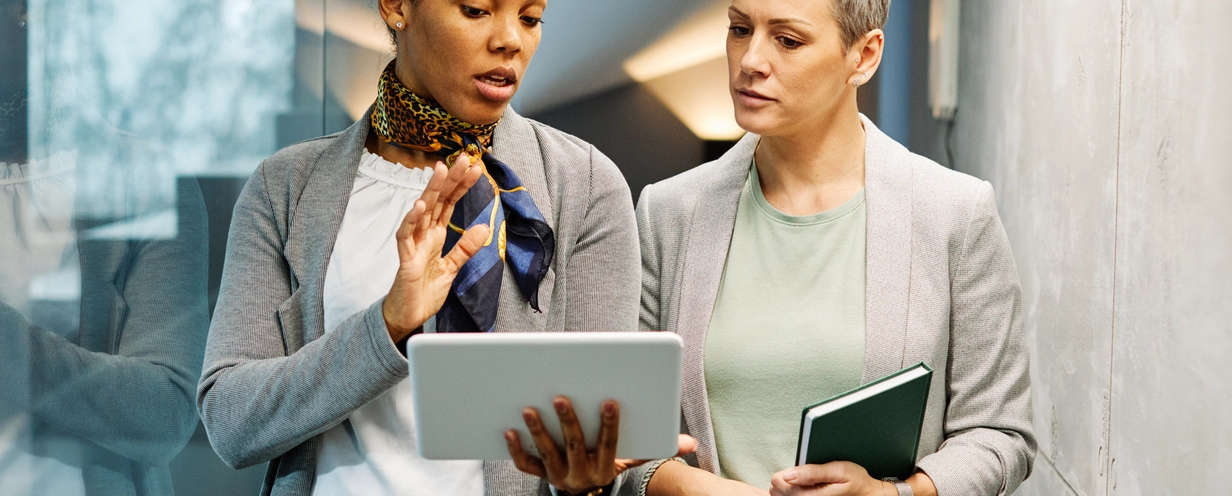 Two women in an office reviewing a document