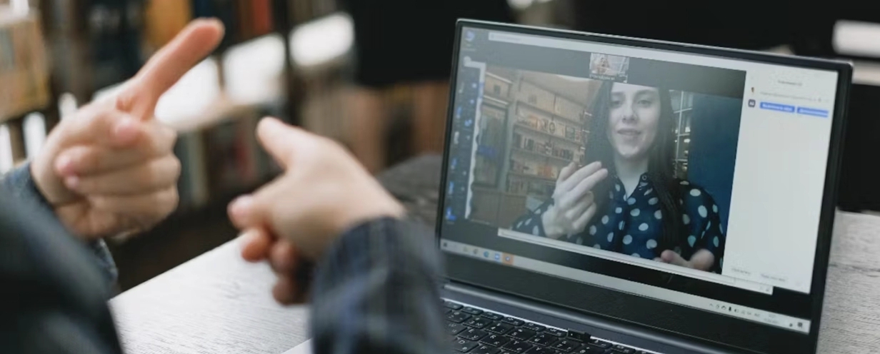 Zoom call showcasing two people communicating through sign language