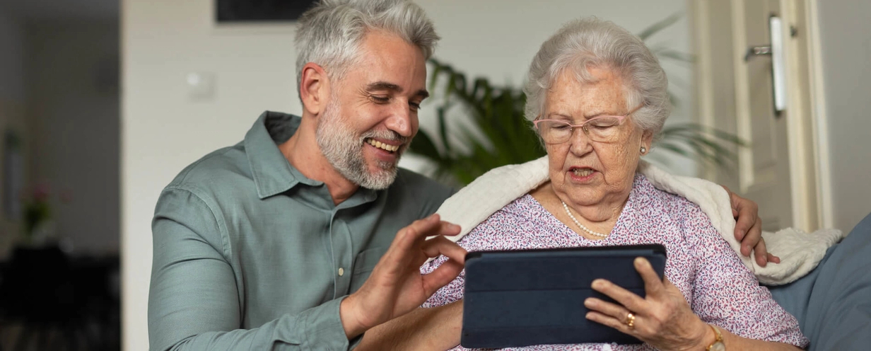 two people infront of an ipad