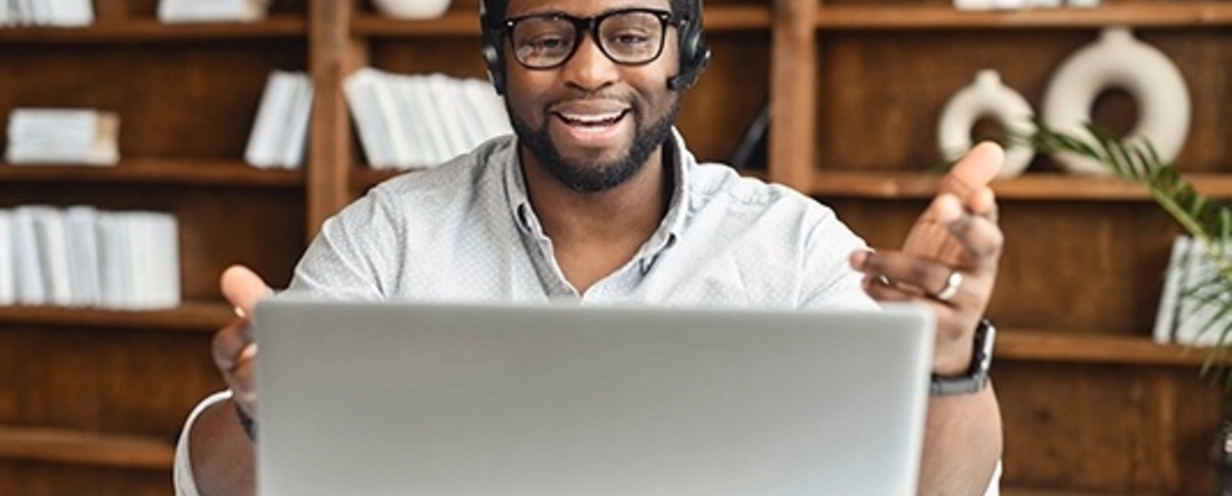 Person on a phone call looking at his laptop