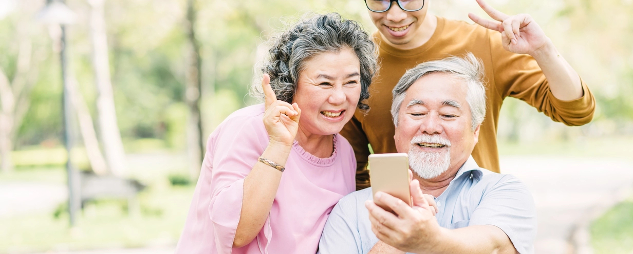 3 generations of people using a mobile phone