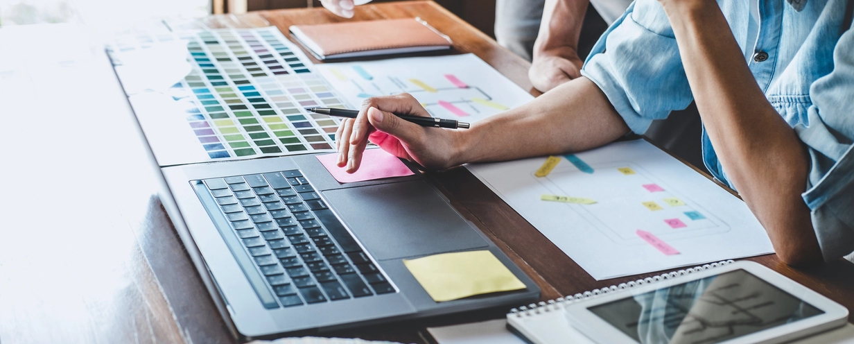 Photo of UX designer and product designers working at a desk