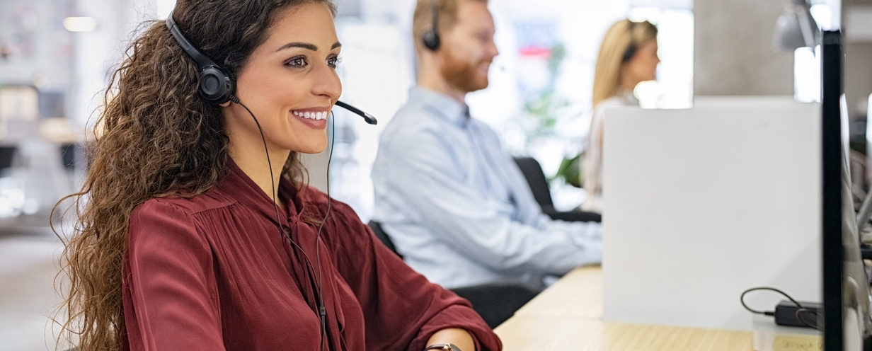 Photo of customer service agents working at a call center