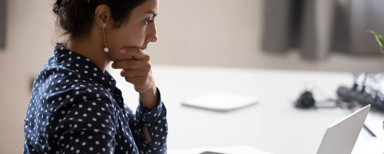 Photo of woman concentrating while looking at laptop