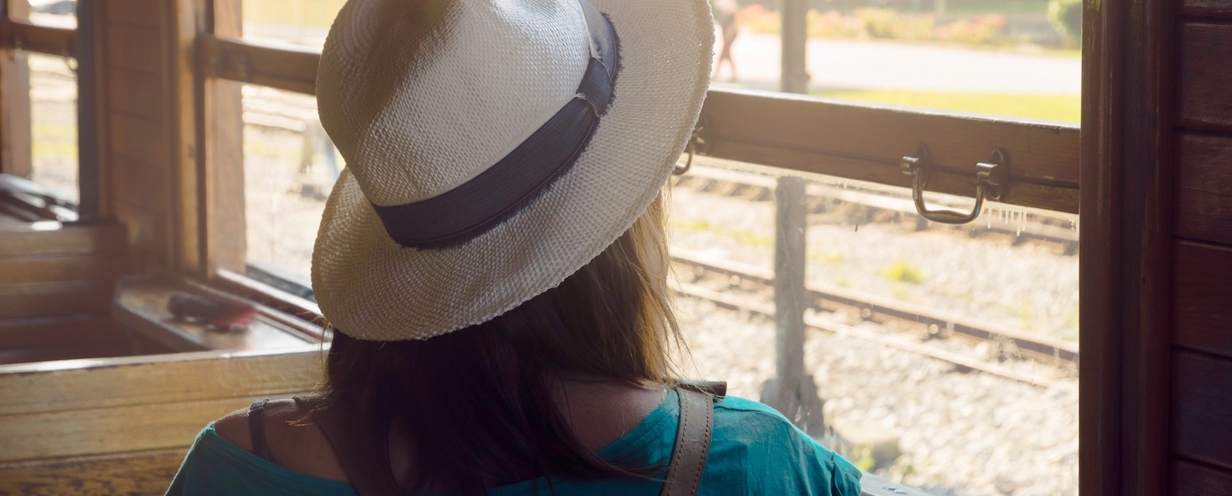 Woman facing away wearing a hat