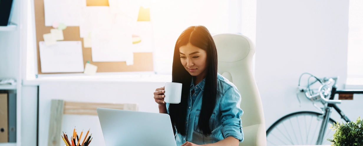 Woman working on her laptop in an office