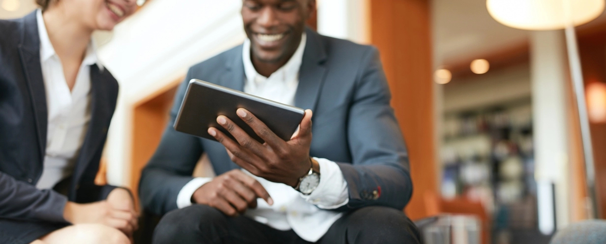 Man showing an ipad screen to a woman