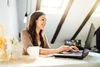 Image of a woman working from home on her laptop