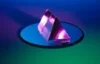 Image of a purple crystal sitting on top of a mirror