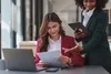 Two women in an office reviewing a document