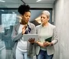 Two women in an office reviewing a document