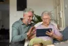 two people infront of an ipad