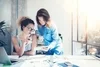 Two women discuss over a tablet.