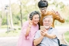 3 generations of people using a mobile phone