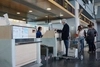 Airline passengers checking in at an airline counter in the Valencia Airport.