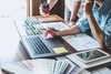 Photo of UX designer and product designers working at a desk