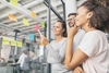 Photo of 3 people at a glass wall using post-it notes to map out the customer journey