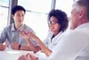 Photo of team at conference table discussing human insights from customers