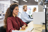 Photo of customer service agents working at a call center