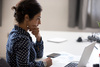 Photo of woman concentrating while looking at laptop