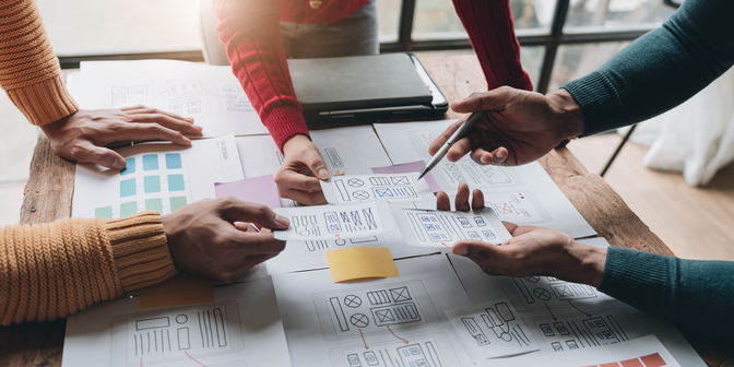 3 designers working on a prototype at a conference table