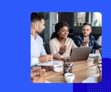 Team sitting at conference table in office